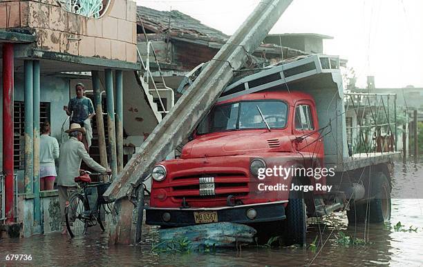 Truck is damaged by an electrical pole that toppled during the onslaught of Hurricane Michelle November 5, 2001 in Jaguey, Cuba.