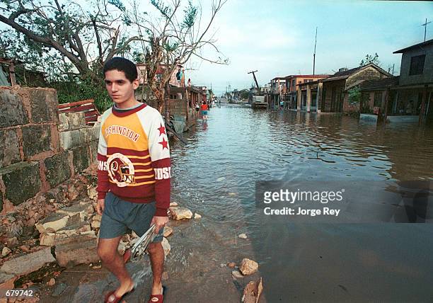 Man walks down a flood street caused by Hurricane Michelle November 5, 2001 in Matanzas County, Cuba.