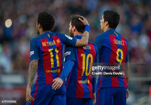 Lionel Messi of FC Barcelona celebrates with Neymar and Luis Suarez after scoring his team's 3rd goal from the penalty spot during of the La Liga...