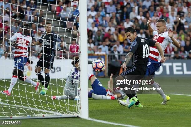 James Rodriguez of Real Madrid scores the opening goal during the La Liga match between Granada CF and Real Madrid CF at Estadio Nuevo Los Carmenes...