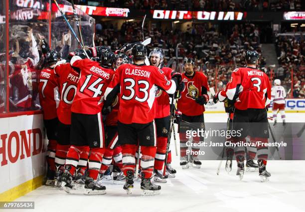 Kyle Turris of the Ottawa Senators celebrates his overtime goal against the New York Rangers with teammates Tom Pyatt, Alexandre Burrows, Fredrik...