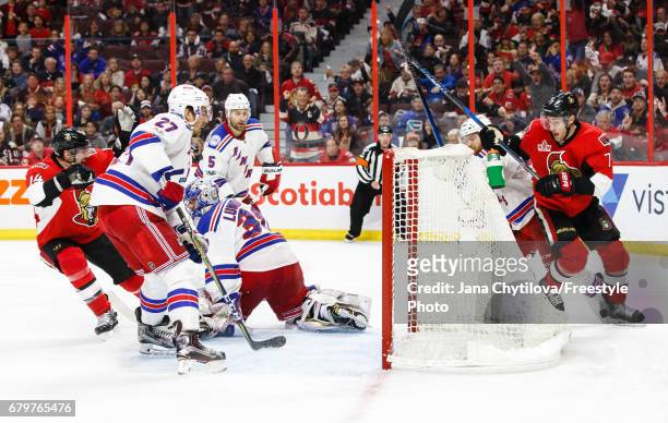 Kyle Turris of the Ottawa Senators scores the overtime goal as Ryan McDonagh, Henrik Lundqvist, and Dan Girardi of the New York Rangers in Game Five...