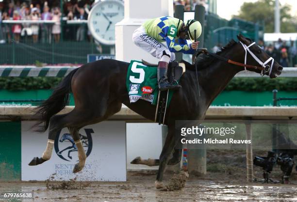 Jockey John Velazquez celebrates as he guides Always Dreaming across the finish line to win the 143rd running of the Kentucky Derby at Churchill...