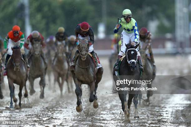 Jockey John Velazquez celebrates atop Always Dreaming as they cross the finish line after winning the 143rd running of the Kentucky Derby at...