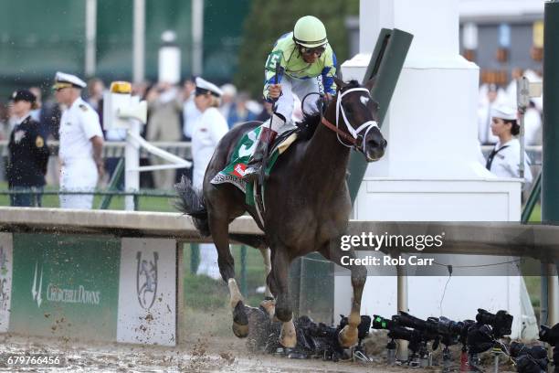 Jockey John Velazquez celebrates as he guides Always Dreaming across the finish line to win the 143rd running of the Kentucky Derby at Churchill...