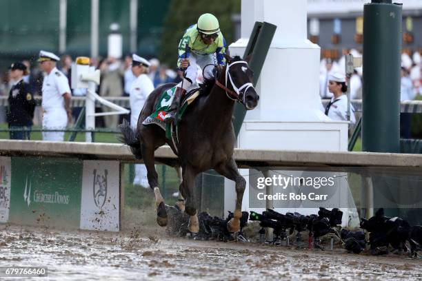 Jockey John Velazquez celebrates as he guides Always Dreaming across the finish line to win the 143rd running of the Kentucky Derby at Churchill...