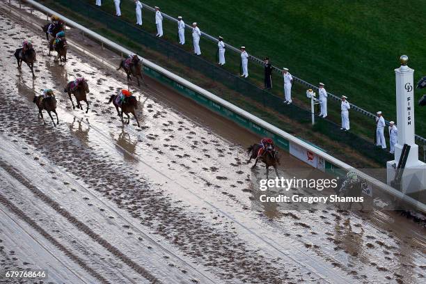 Jockey John Velazquez celebrates as he guides Always Dreaming across the finish line to win the 143rd running of the Kentucky Derby at Churchill...