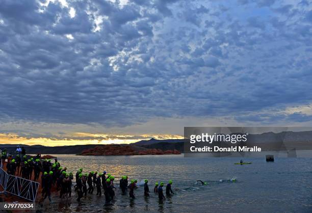 Competitors enter the water at sunrise during the IRONMAN 70.3 St. George Utah on May 6, 2017 in St. George, Utah.