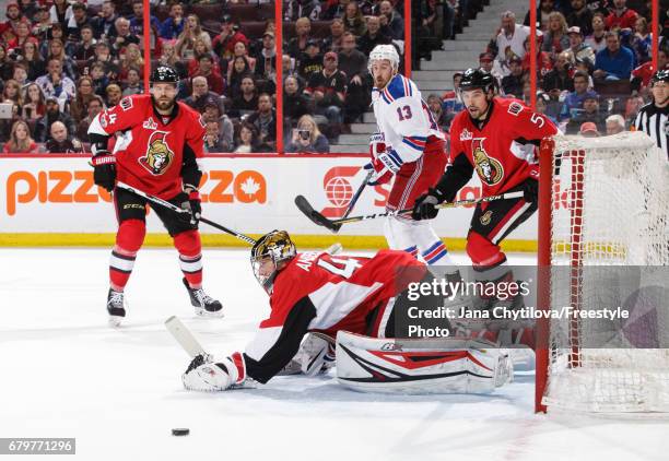 The puck gets past Craig Anderson of the Ottawa Senators after teammate Viktor Stalberg made an errant pass in front of the net as Kevin Hayes of the...