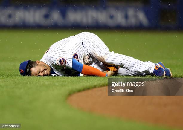 Asdrubal Cabrera of the New York Mets screams as he is injured fielding a hit by Marcell Ozuna of the Miami Marlins in the third inning on May 6,...