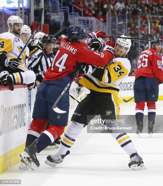 Justin Williams of the Washington Capitals gets the stick up on Tom Kuhnhackl of the Pittsburgh Penguins during the second period in Game Five of the...