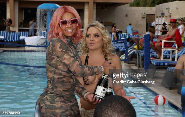 Model Blac Chyna and adult film actress Alexis Texas prepare to spray guests with champagne during a pool party at Sapphire Pool & Day Club on May 6,...