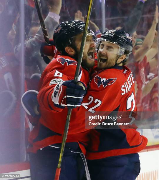 Alex Ovechkin of the Washington Capitals scores at 7:47 of the third period against the Pittsburgh Penguins and is embraced by Kevin Shattenkirk in...