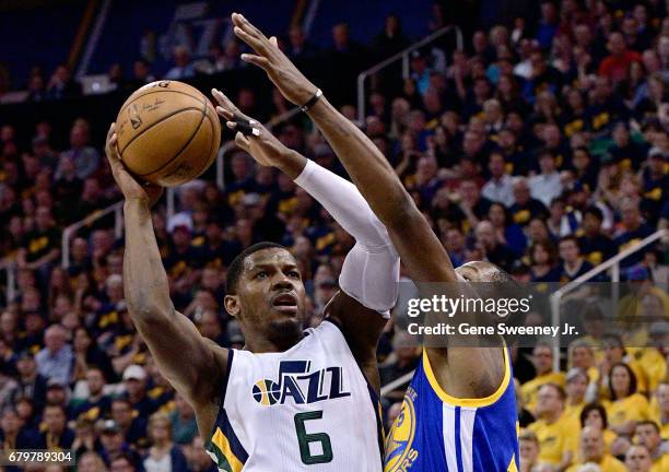 Joe Johnson of the Utah Jazz tries for the basket past the defense of Kevin Durant of the Golden State Warriors in the first half in Game Three of...