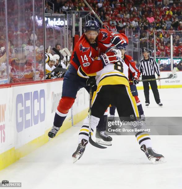 Justin Williams of the Washington Capitals attempts to get past Brian Dumoulin of the Pittsburgh Penguins during the third period in Game Five of the...