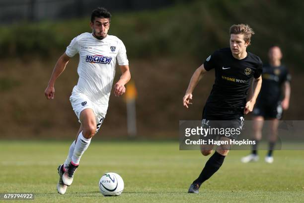Emiliano Tade of Auckland City attempts to beat the defence of Andy Bevin of Team Wellington during the OFC Champions League Final match between Team...
