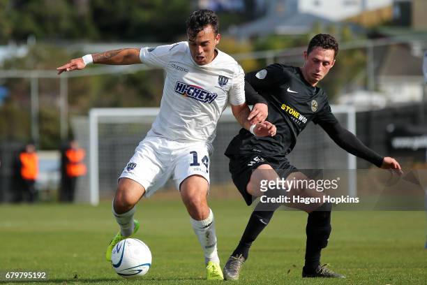 Clayton Lewis of Auckland City holds off the challenge of Joel Stevens of Team Wellington during the OFC Champions League Final match between Team...