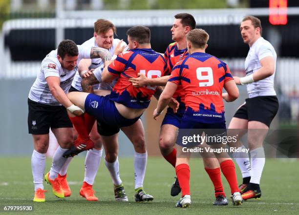 Sean Penkywicz, Jacob Emmitt and Greg Worthington of Toronto Wolfpack dump Jake Joynt of the Oxford RLFC to the ground during the second half of a...