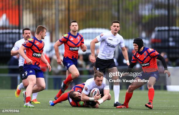 Andrew Dixon of Toronto Wolfpack is tackled by Josh Scott of Oxford RLFC during the second half of a Kingstone Press League 1 match at Lamport...