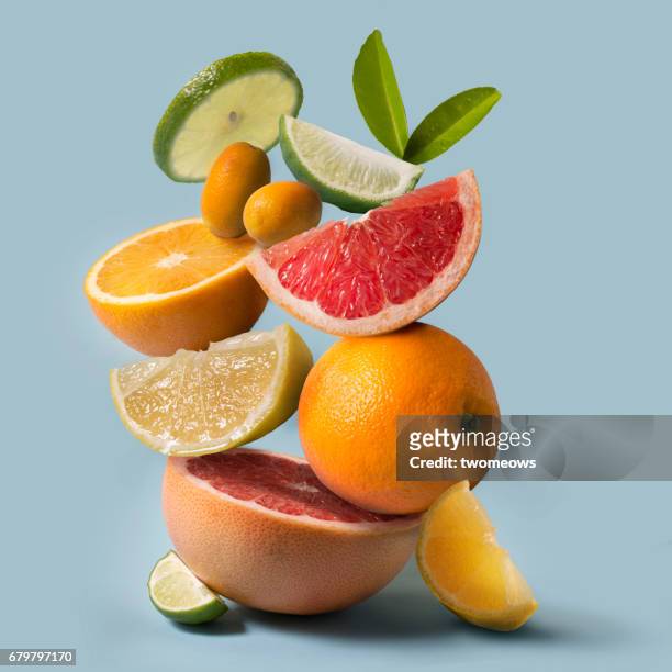 assorted citrus fruits stack still life. - obst stock-fotos und bilder
