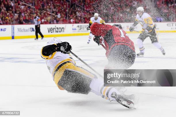Brian Dumoulin of the Pittsburgh Penguins takes a second period penalty for trippinng Justin Williams of the Washington Capitals in Game Five of the...