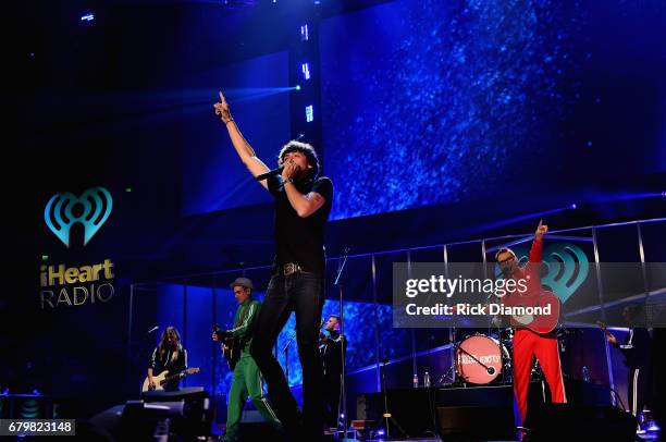 Singer Chris Janson performs onstage with Bobby Bones and the Raging Idiots during the 2017 iHeartCountry Festival, A Music Experience by AT&T at The...