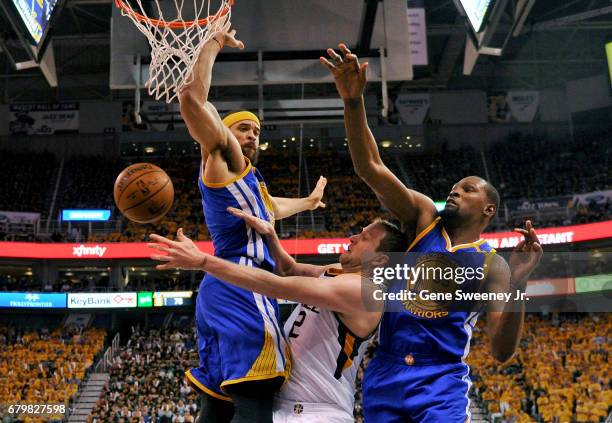 Joe Ingles of the Utah Jazz passes around the defense of JaVale McGee and Kevin Durant of the Golden State Warriors in the second half of the Jazz...