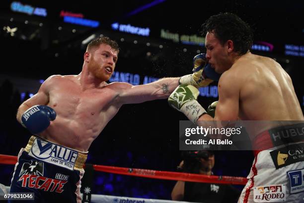 Canelo Alvarez punches Julio Cesar Chavez Jr. During their catchweight bout at T-Mobile Arena on May 6, 2017 in Las Vegas, Nevada. Alvarez won by...