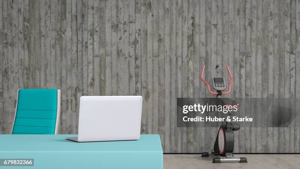 modern sideboard, exercise bike in background - architektur büro foto e immagini stock