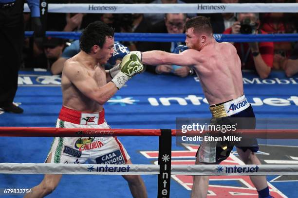 Canelo Alvarez punches Julio Cesar Chavez Jr. During their catchweight bout at T-Mobile Arena on May 6, 2017 in Las Vegas, Nevada. Alvarez won by...