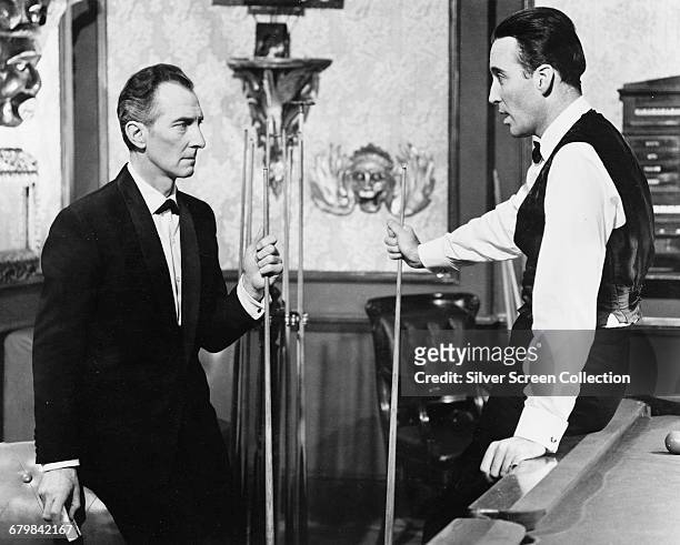 British actors Peter Cushing as Dr. Christopher Maitland and Christopher Lee as Sir Matthew Phillips in the British horror film 'The Skull', 1965.