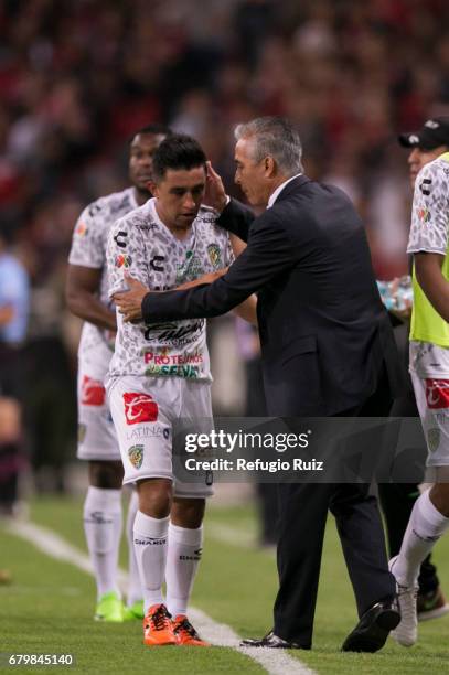 Christian Bermudez of Chiapas celebrates with coach Sergio Bueno after scoring his team's first goal during the 17th round match between Atlas and...