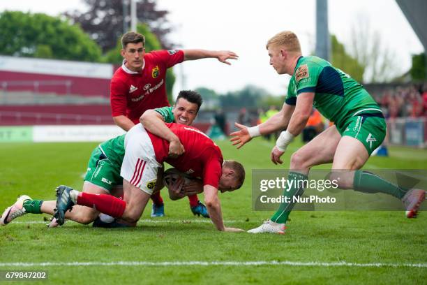 Keith Earls of Munster tackled by Cian Kelleher of Connacht during the Guinness PRO12 rugby match between Munster Rugby and Connacht Rugby at Thomond...