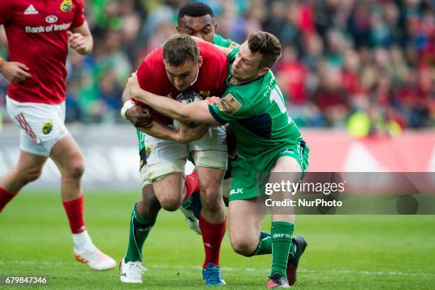 Tommy O'Donnell of Munster tackled by Jack Carty of Connacht during the Guinness PRO12 rugby match between Munster Rugby and Connacht Rugby at...