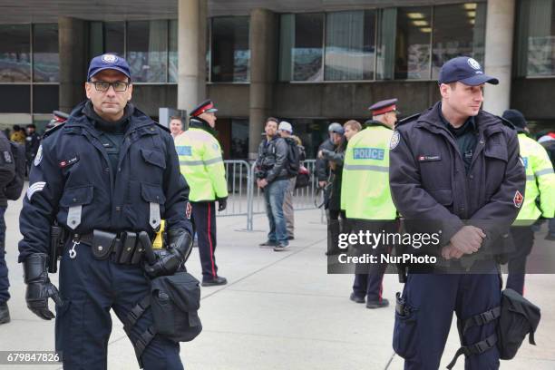 Police stand guard during a rally against Islam, Muslims, and Sharia Law in downtown Toronto, Ontario, Canada, on May 06, 2017. Groups such as the...