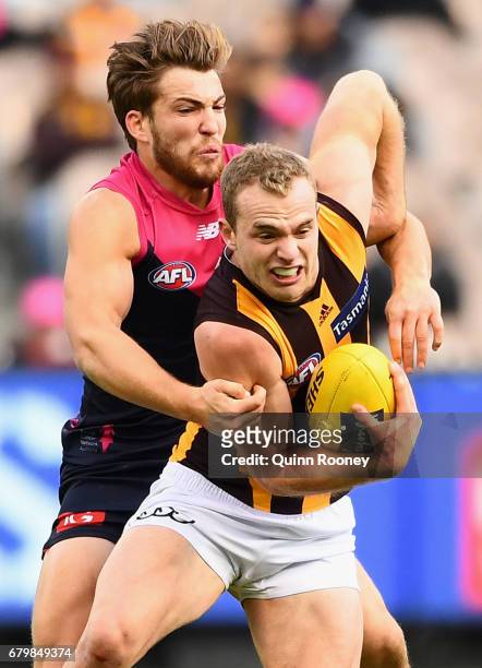 Tom Mitchell of the Hawks is tackled by Jack Viney of the Demons during the round seven AFL match between the Melbourne Demons and the Hawthorn Hawks...