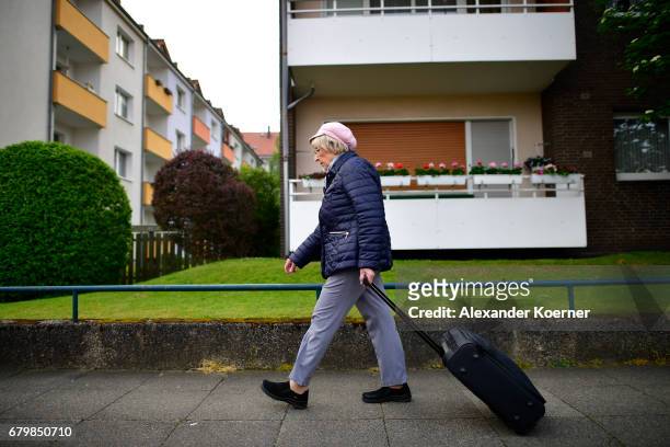 An elderly woman walks by a barricaded apartment complex as part of the evacuation of 50,000 people on May 7, 2017 in Hanover, Germany. Bomb disposal...
