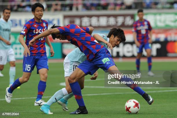 Koki Ogawa of Jubilo Iwata and Eder Lima of Ventforet Kofu compete for the ball during the J.League J1 match between Ventforet Kofu and Jubilo Iwata...