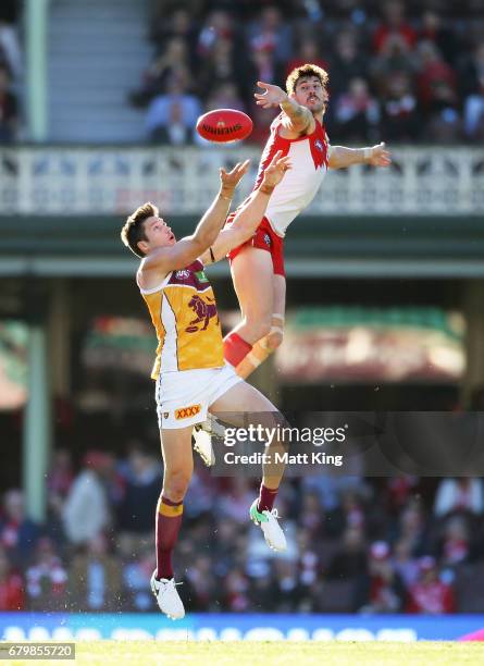 Sam Naismith of the Swans is challenged by Stefan Martin of the Lions during the round seven AFL match between the Sydney Swans and the Brisbane...