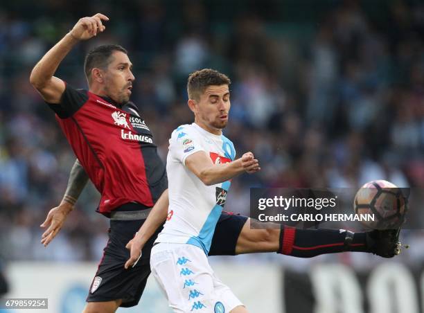 Cagliari's Italian forward Marco Borriello fights for the ball with Napoli's Italian midfielder Brazilian-born Jorginho during the Italian Serie A...