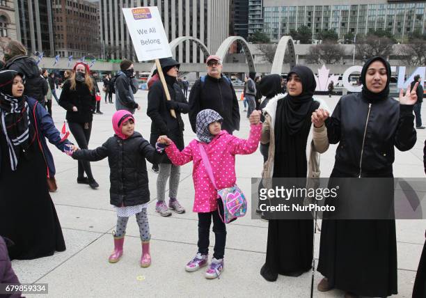 Muslim women and children form a 'circle of peace' during a rally against Islamophobia, White Supremacy &amp; Fascism in downtown Toronto, Ontario,...