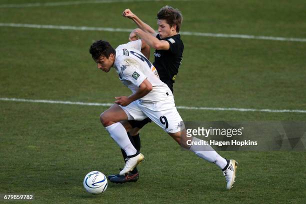 Darren White of Auckland City is tackled by Andy Bevin of Team Wellington during the OFC Champions League Final match between Team Wellington and...