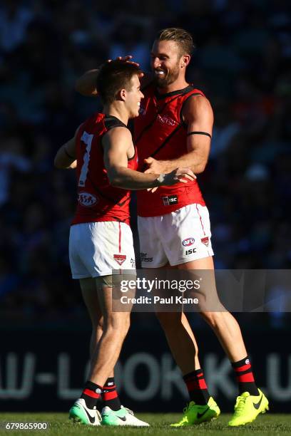 Zach Merrett and Cale Hooker of the Bombers celebrate a goal during the round seven AFL match between the Fremantle Dockers and the Essendon Bombers...