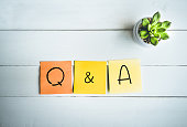 Q & A word with paper note on wood table
