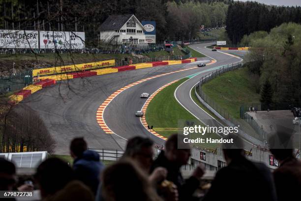 In this handout image provided by Red Bull, Cars race up through Eau Rouge to the Raidillon as spectators eat dinner on a balcony during the 6 Hours...