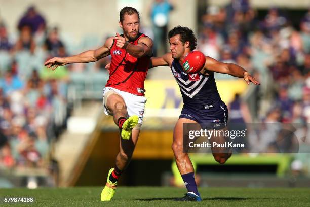James Kelly of the Bombers gets his kick away before being tackled by Brady Grey of the Dockers during the round seven AFL match between the...