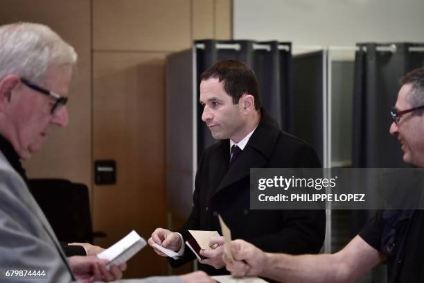 Former French Socialist party candidate Benoit Hamon prepares to vote at a polling station in Trappes, Paris' suburb, on May 7 during the second...