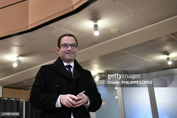 Former French Socialist party candidate Benoit Hamon smiles before voting at a polling station in Trappes, Paris' suburb, on May 7 during the second...