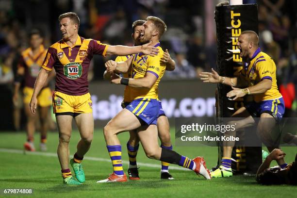 Damien Cook of Country looks dejected as Chad Townsend, Bryce Cartwright and Nathan Ross of City celebrate a late try to Bryce Cartwright which...