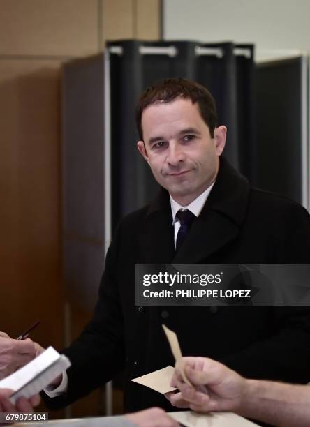 Former French Socialist party candidate Benoit Hamon prepares to cast his ballot at a polling station in Trappes, Paris' suburb, on May 7 during the...